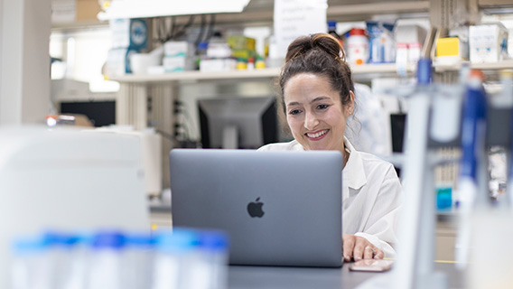Victoria Vieira-Potter sitting in front of a Macbook smiling